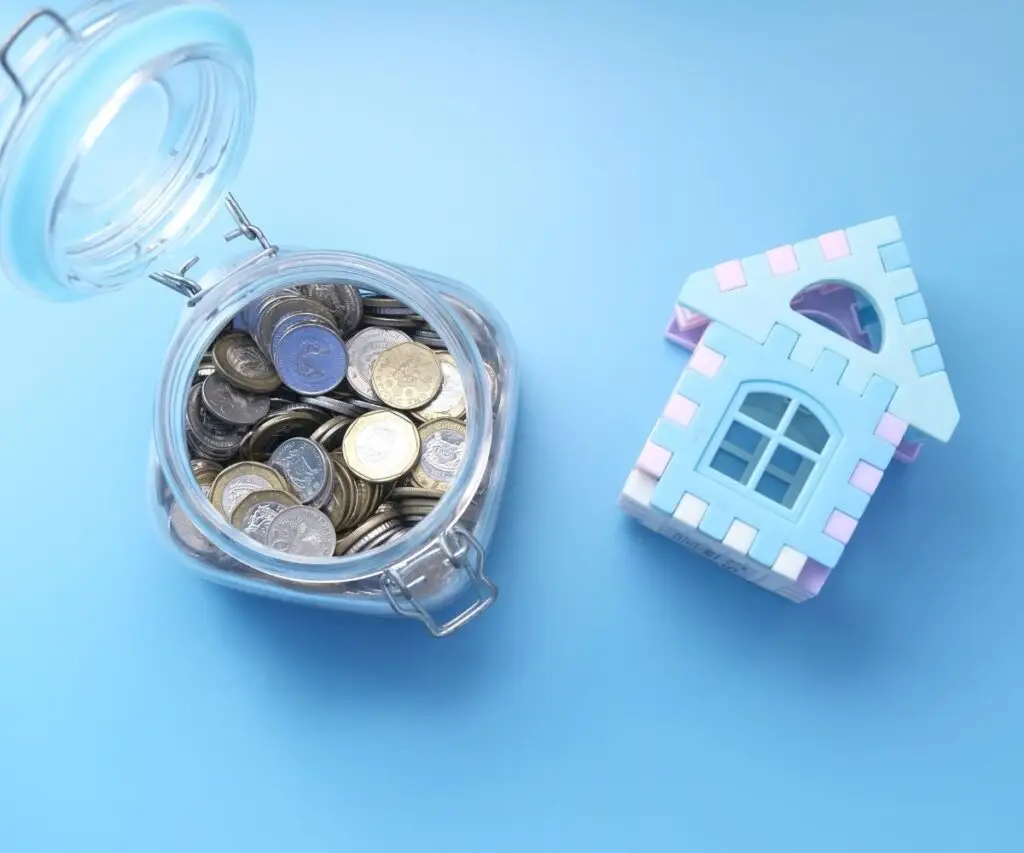 Mortgage Products a blue toy house and a jar of coins