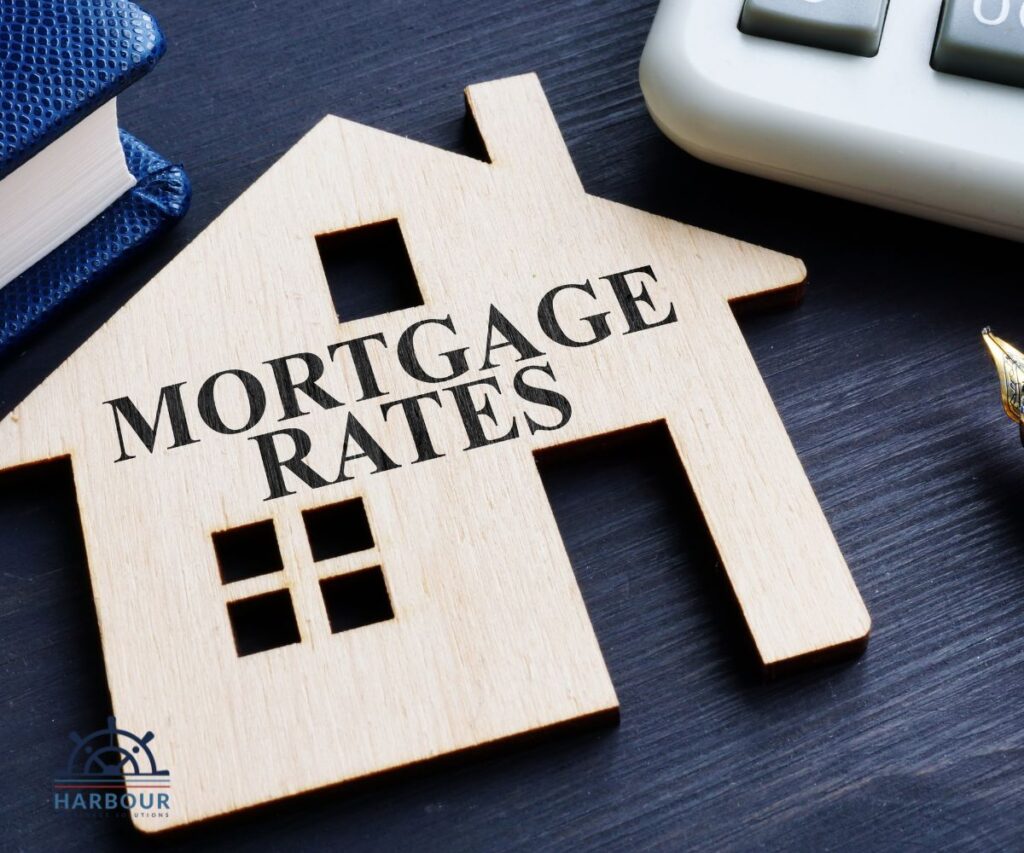 A wooden 2d house cut out with mortgage rates cut our of it