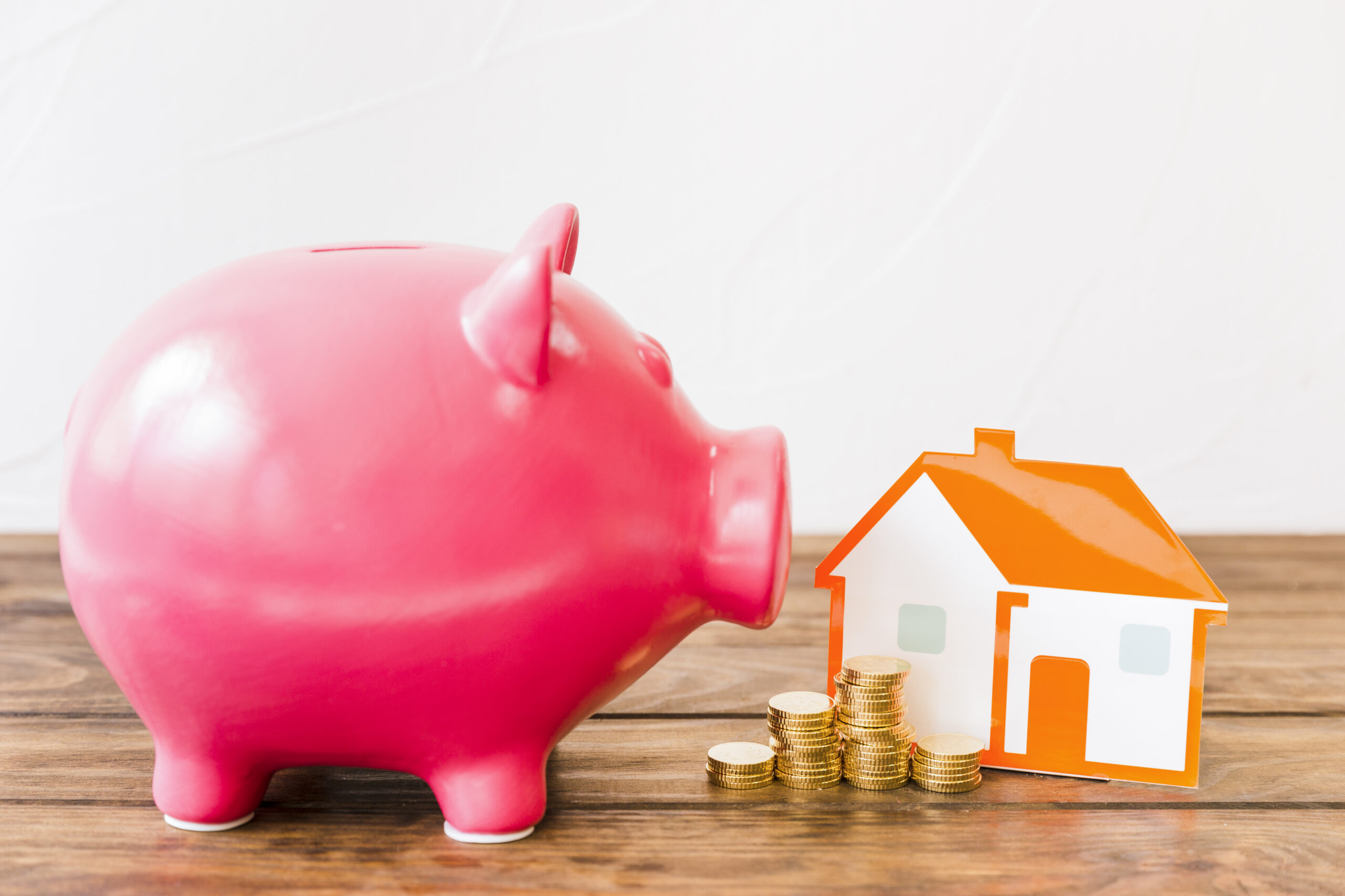 Mortgage Advisors in South Wales and Piggy bank with a house and coins