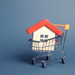 a house in a trolley on a blue background for Mortgage rates UK blog