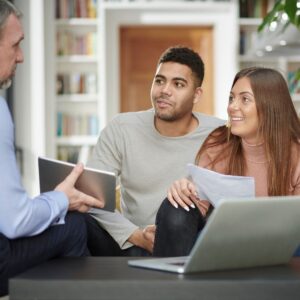 a couple chatting to a mortgage broker