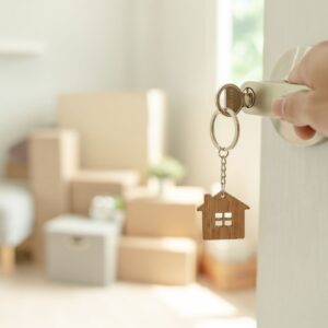 A key with a house chain opens the door to a new house